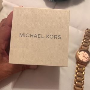 Michael Kors woman rose gold watch.